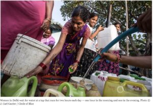 Women in Delhi wait for water at a tap that runs for two hours each day — one hour in the morning and one in the evening. Photo © J. Carl Ganter / Circle of Blue